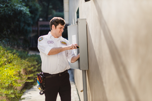 Electrical Panel Replacement Fort Myers, FL shows technician working on outdoor electrical panel