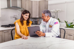 Fort Myers, FL Meter Can Replacement technician sitting with customer at table and talking.