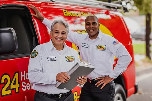 Two Mister Sparky Electricians standing in front of their work van in Fort Myers