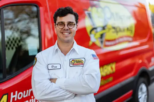 Closeup of Mister Sparky Electrician Tech, Dan, standing in front of his work van at a home in Fort Myers